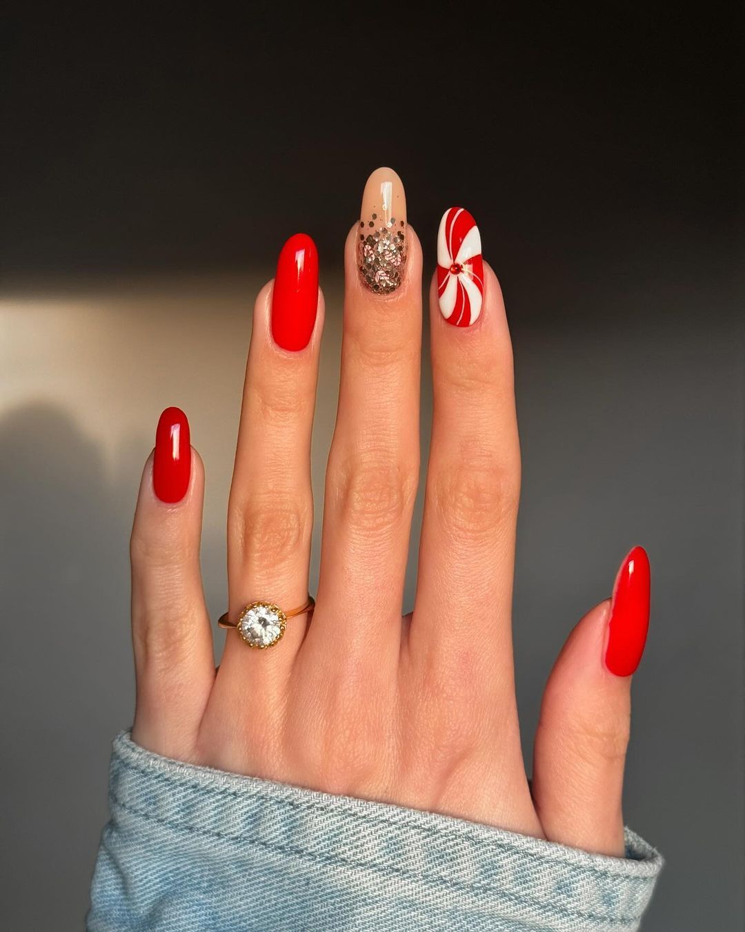 Scarlet red nails with gold glitter and peppermint swirl accents