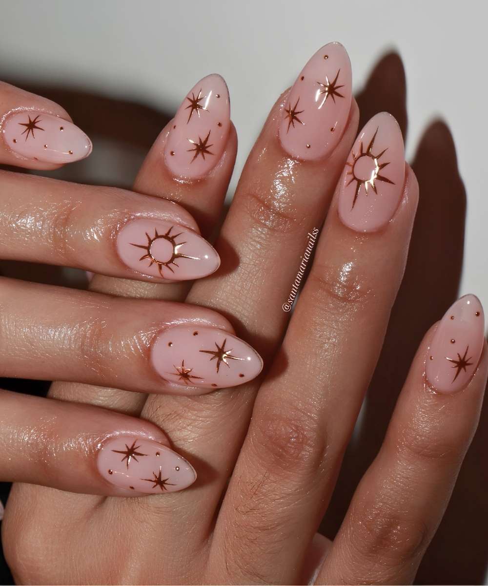 Sheer pink and gold celestial manicure