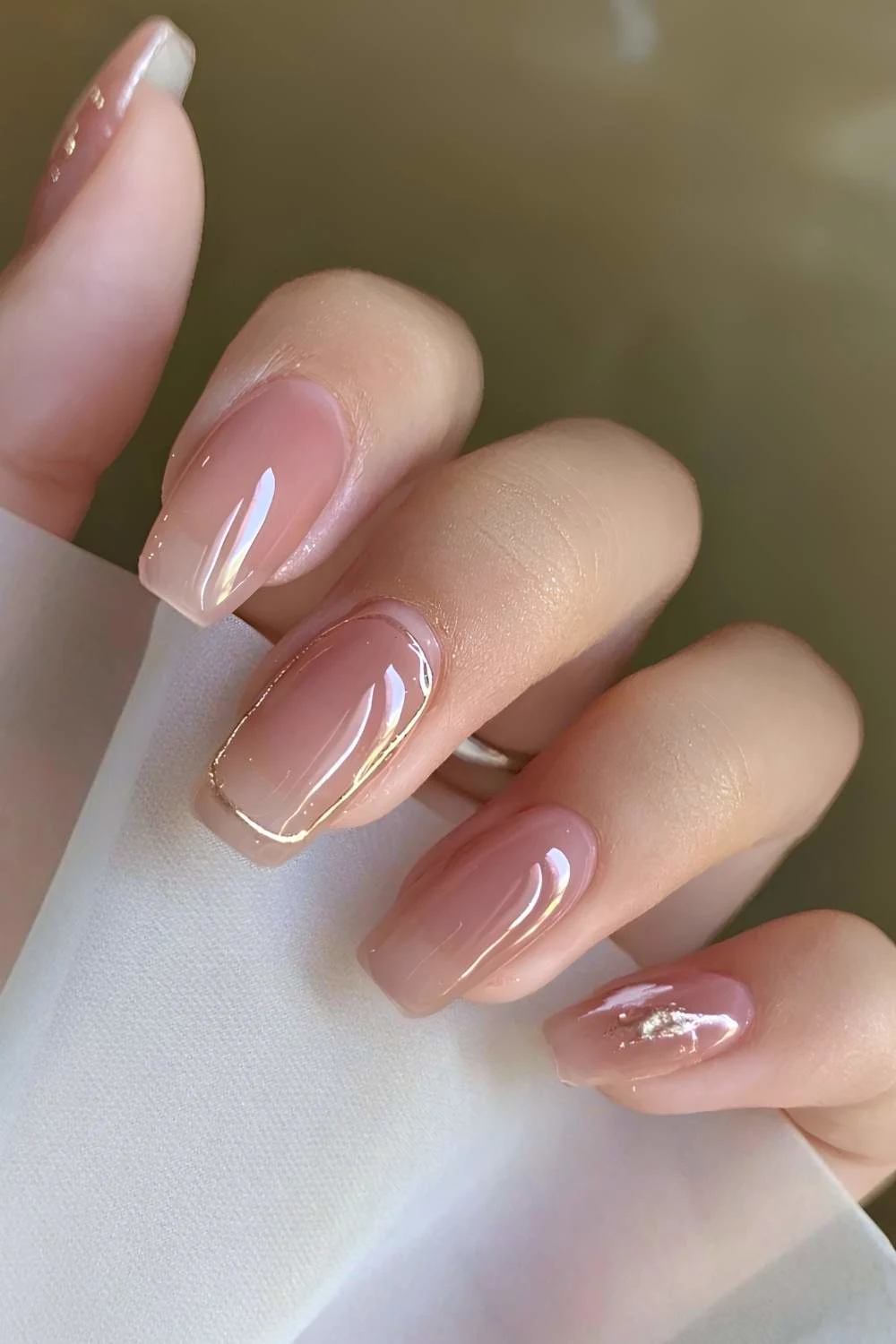 Sheer pink nails with gold accents