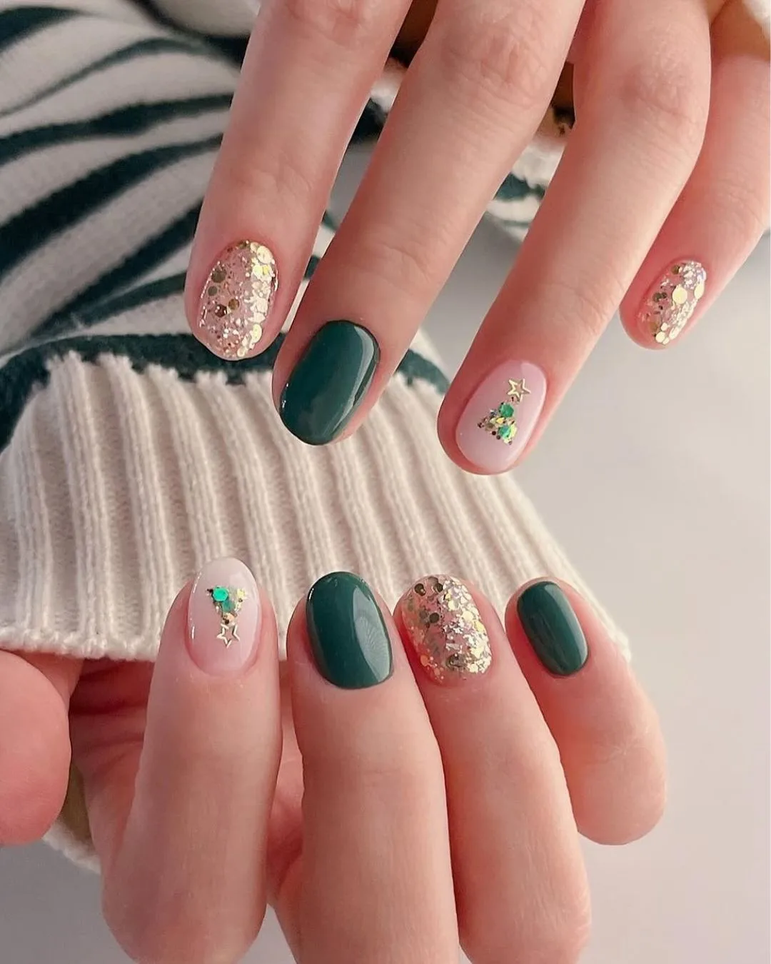 Short green and glittery gold nails with christmas tree accents