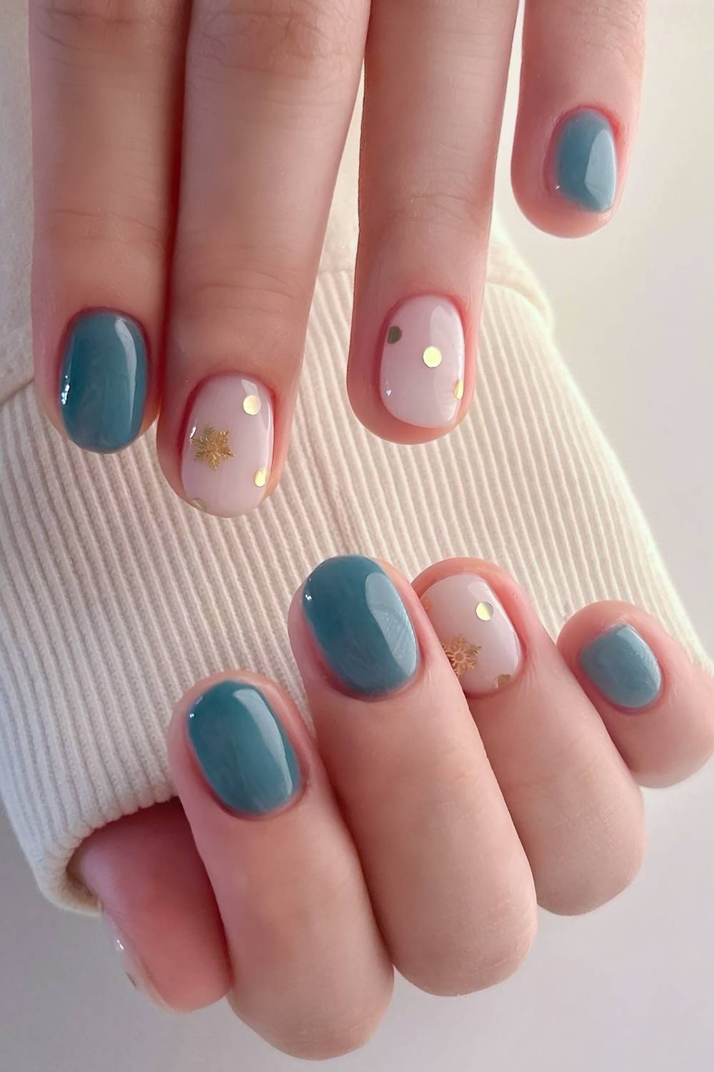 Soft green nails with gold snowflakes and confetti