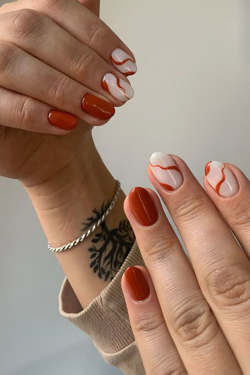 Terracotta orange and white nails with swirls