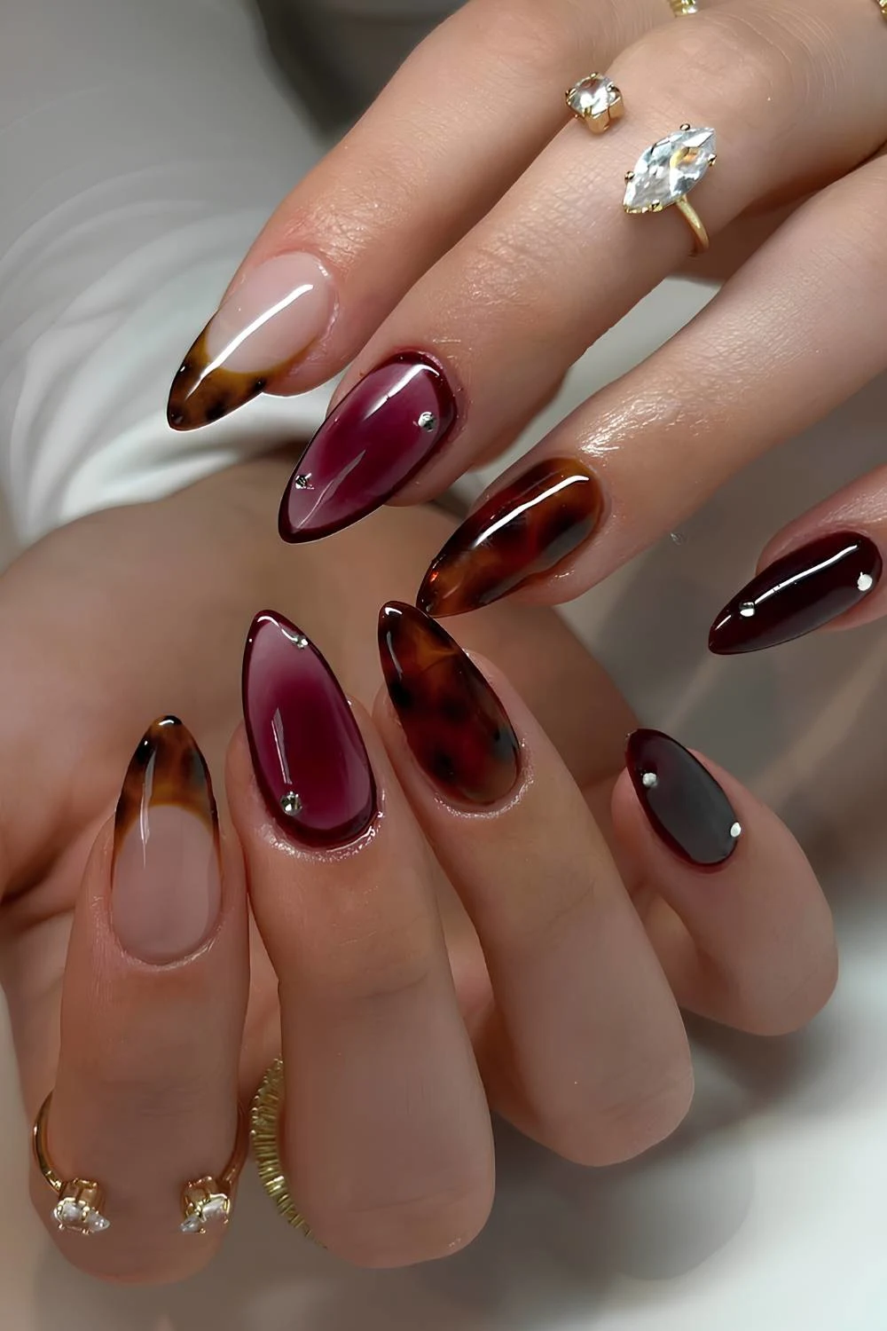 Tortie shell nails with plum aura accent