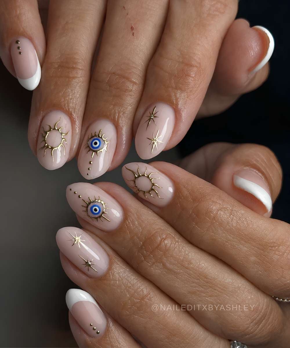 White nails with evil eye and gold celestial art