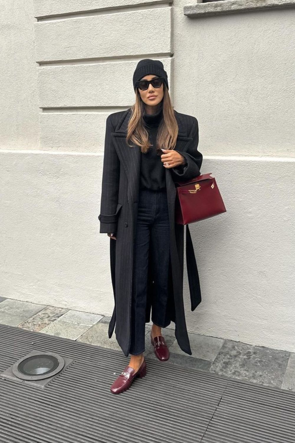 black coat with burgundy bag and shoes