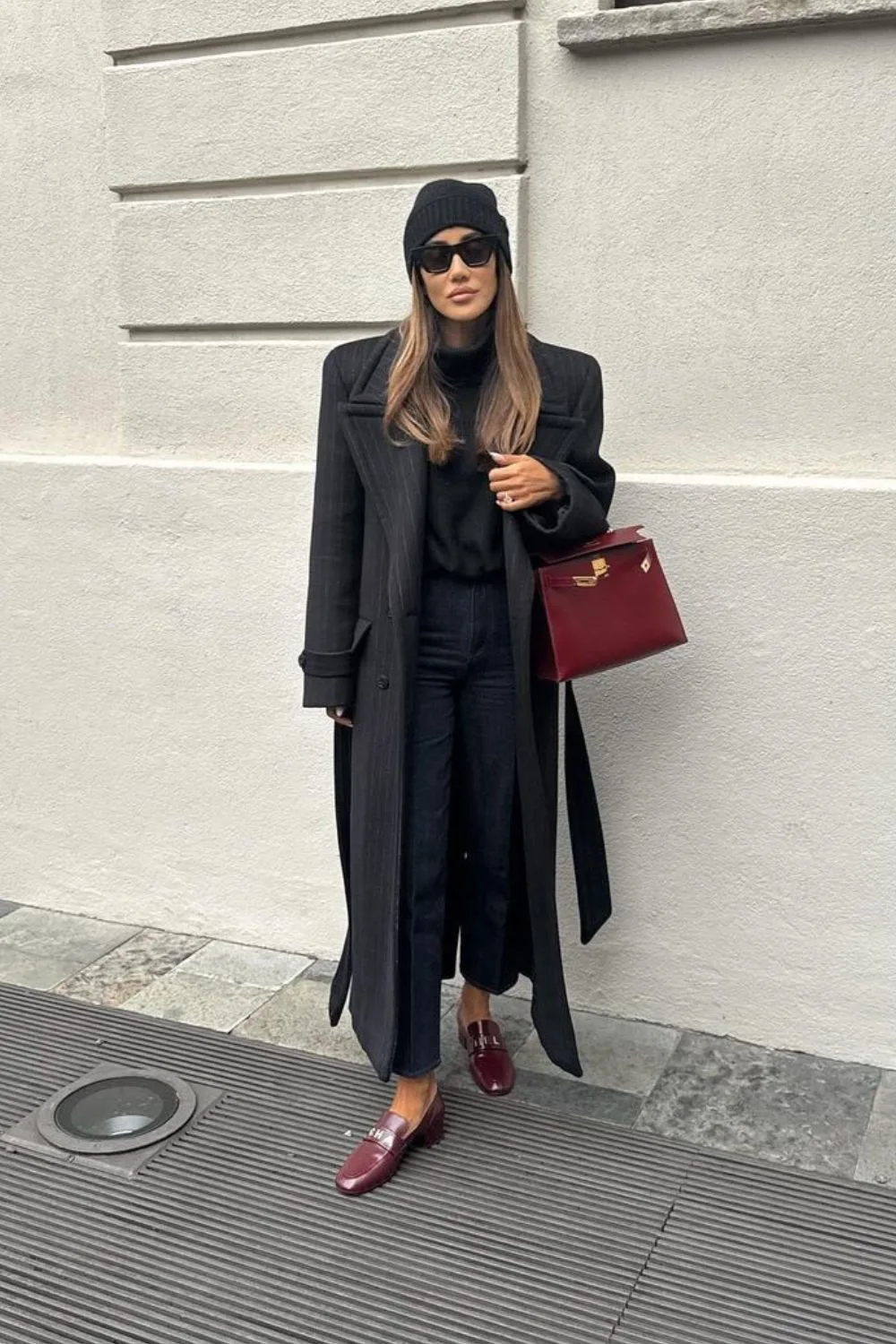 black coat with burgundy bag and shoes