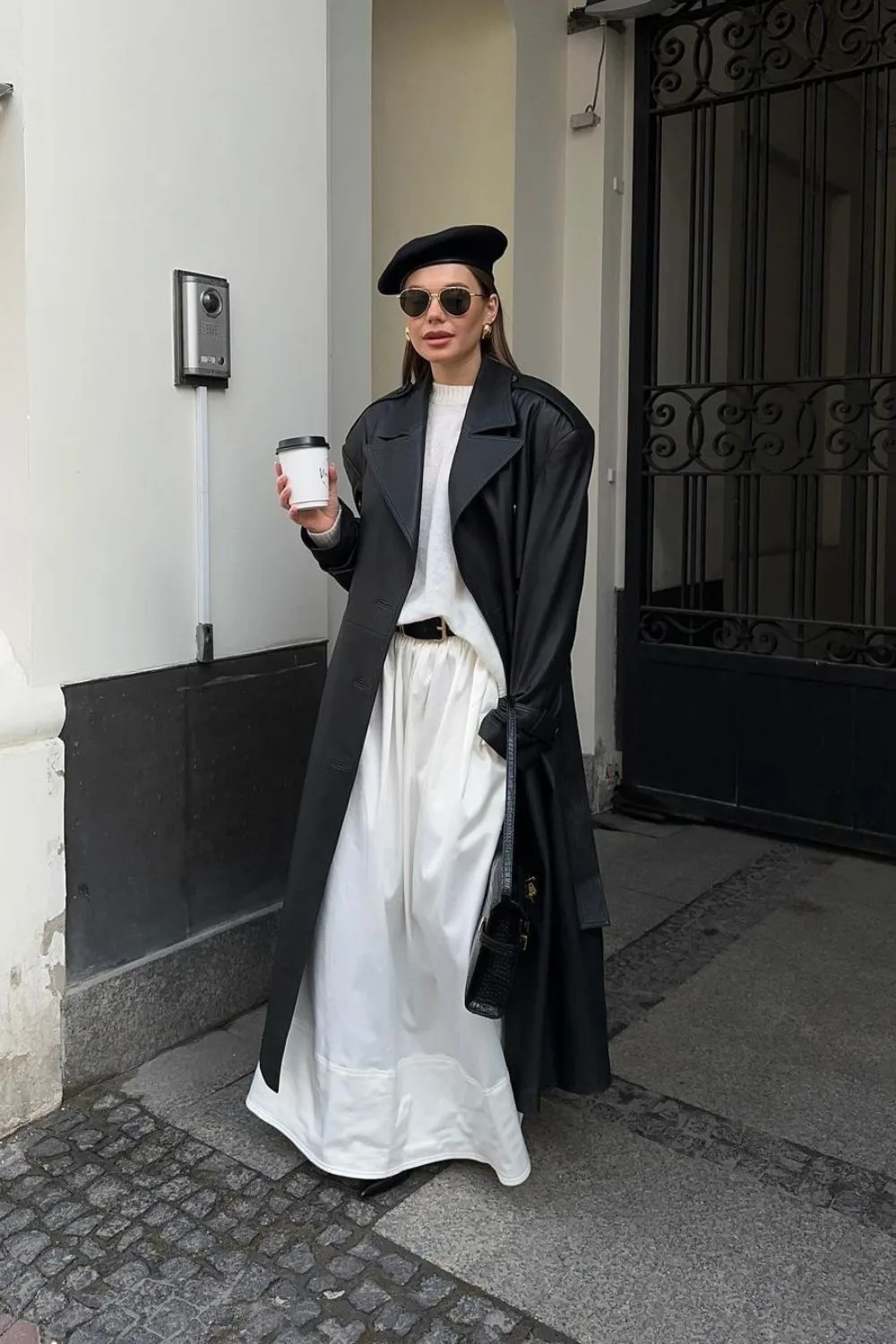 black leather maxi coat with maxi white skirt and a black beret