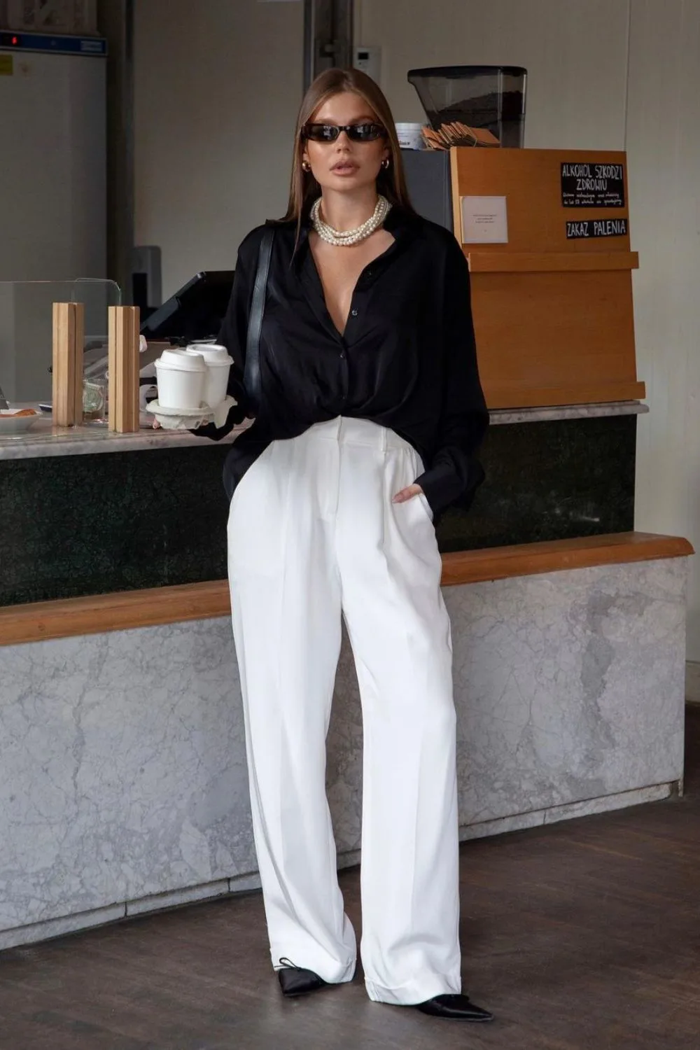 black silk shirt and white wide leg pants and pearl necklace