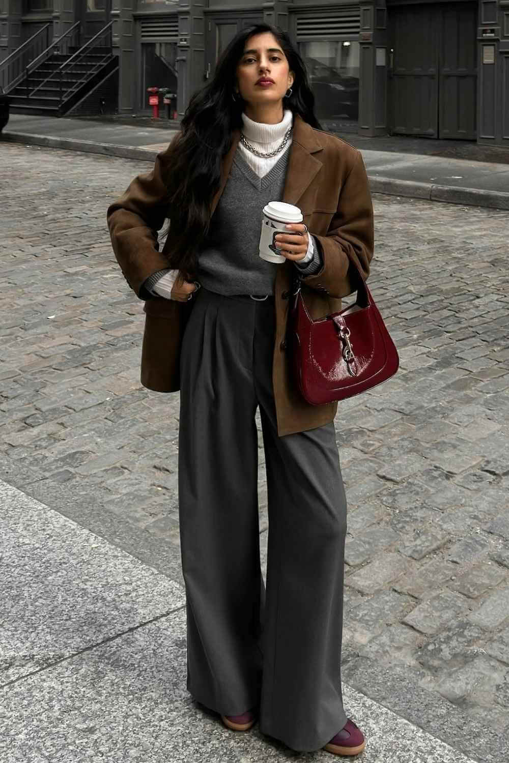 brown suede blazer with gray sweater and wide trousers