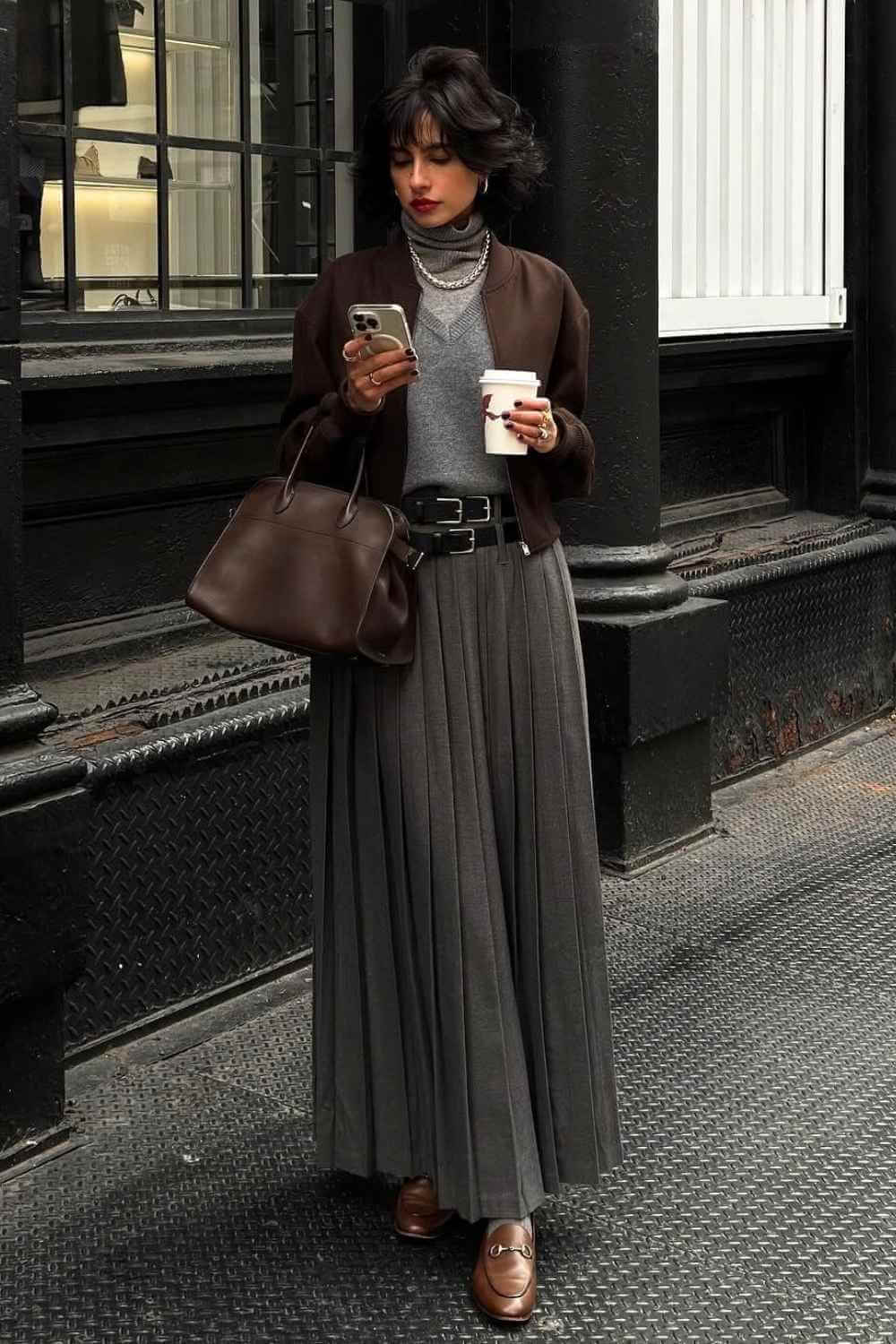 charcoal pleated maxi skirt with brown bomber jacket