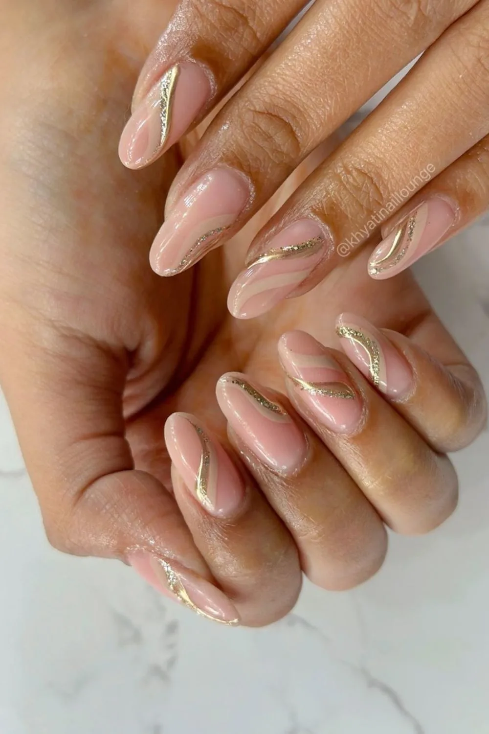 gold and nude swirls on nails