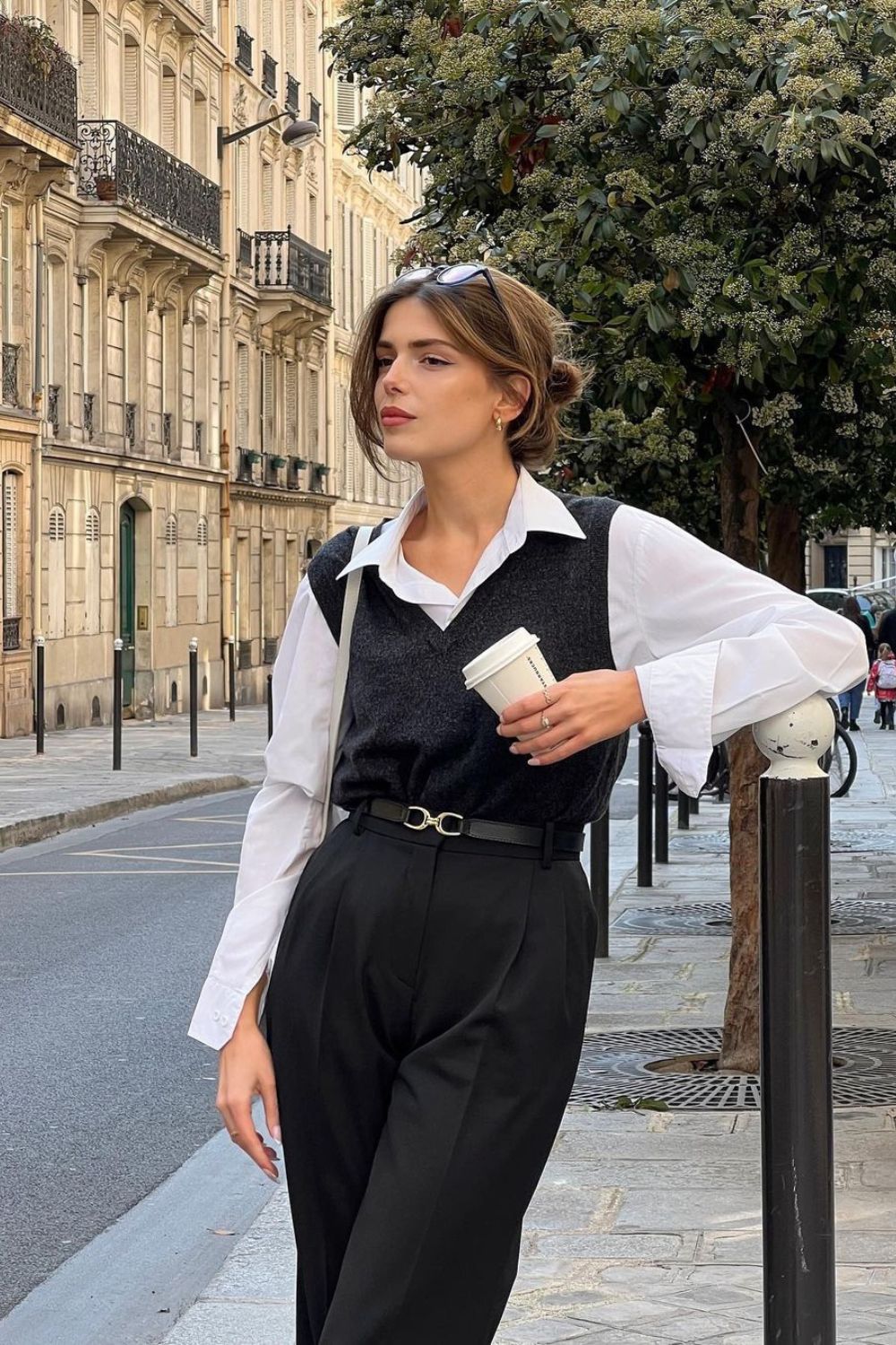 gray sweater vest with white shirt paired with black pants