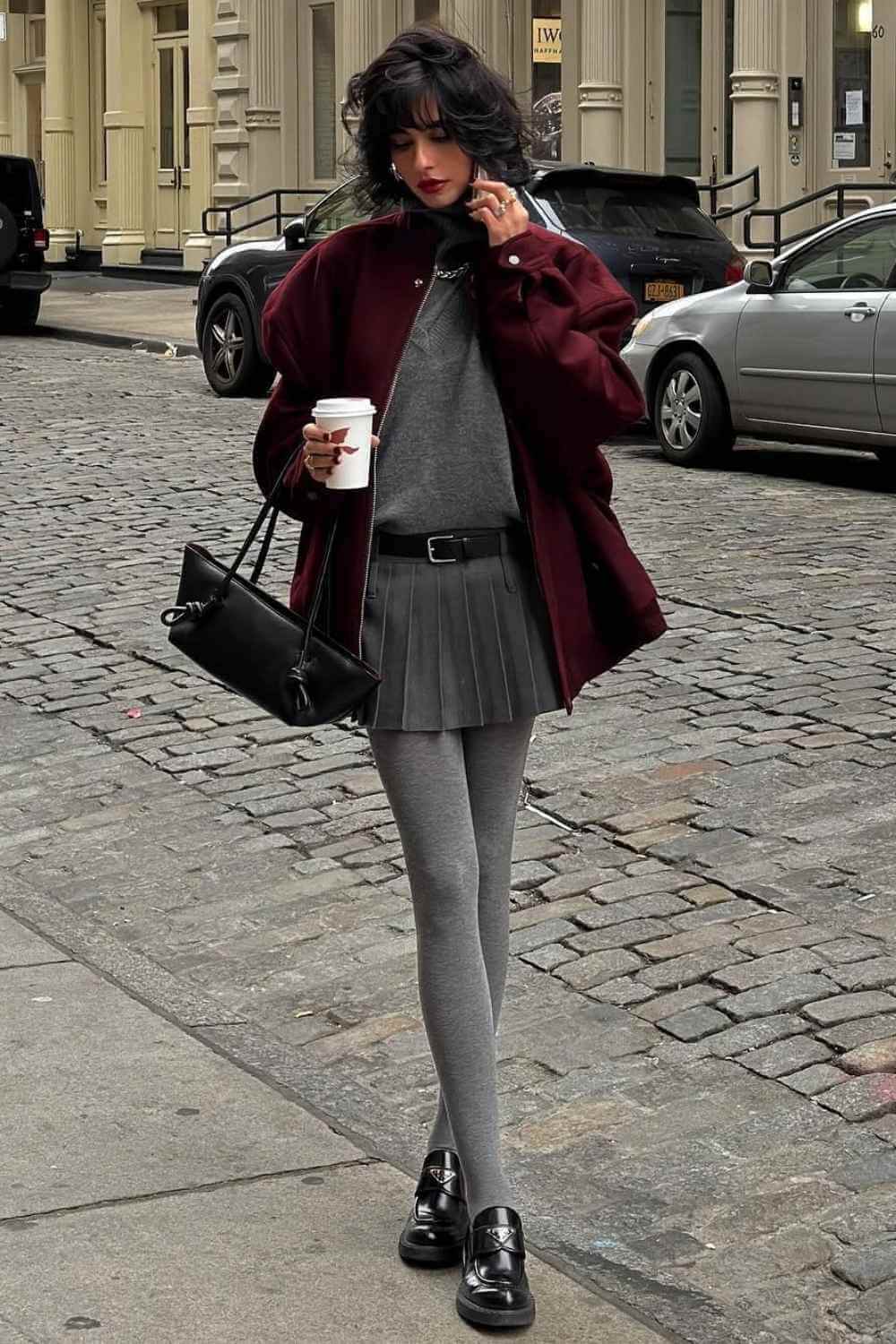 gray tights with pleated mini skirt and burgundy bomber