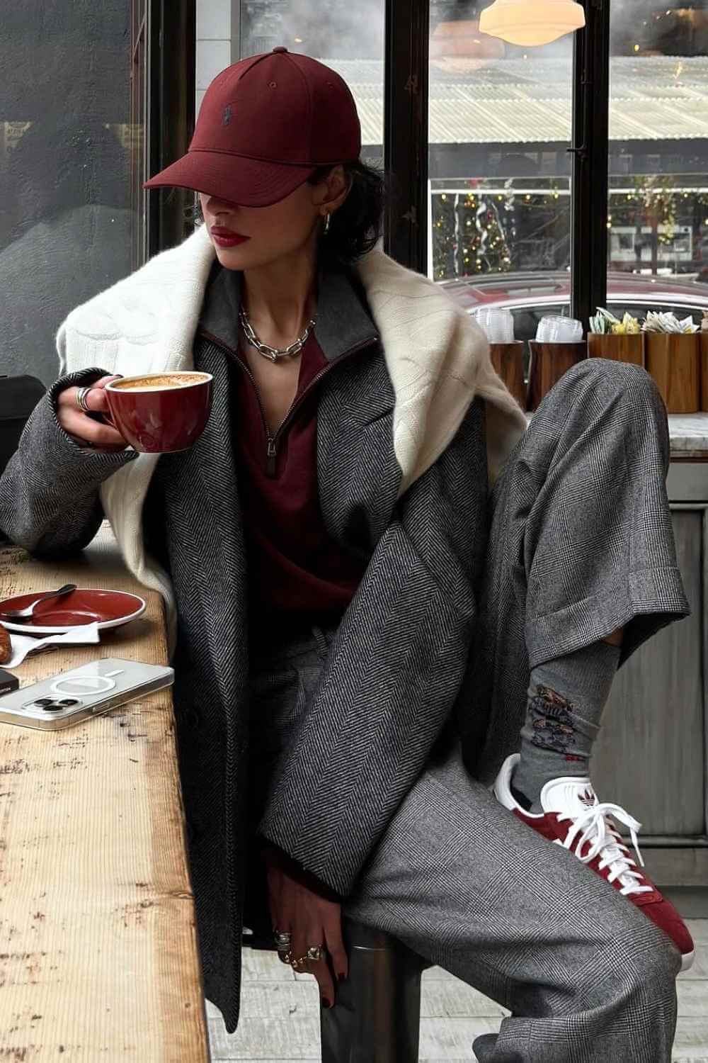 herringbone coat with burgundy cap and sneakers
