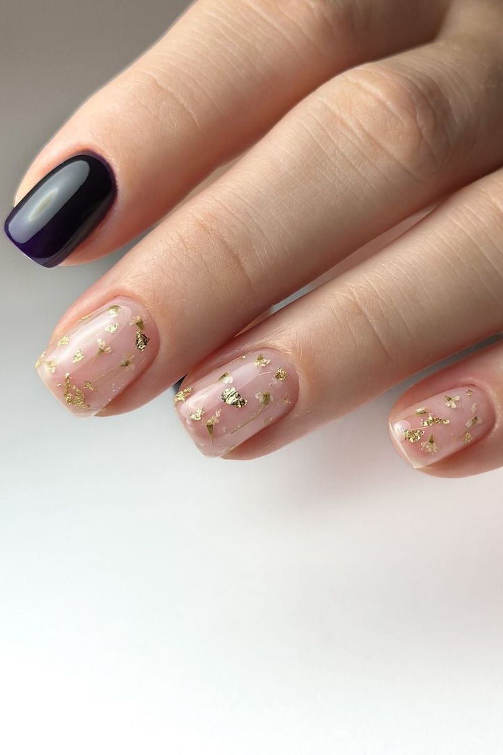 plum and nude nails with gold accents