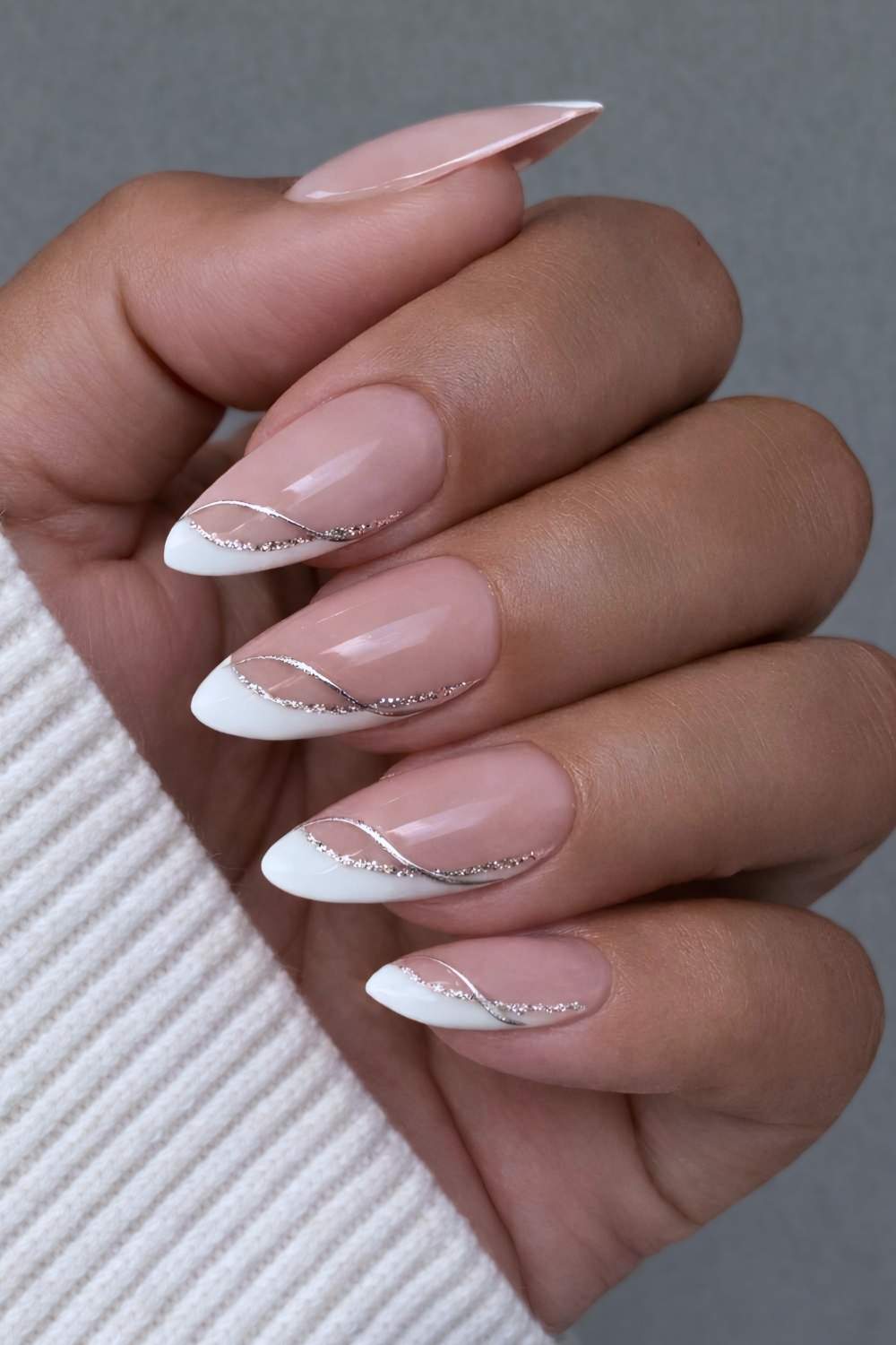 Angled white French mani with glitter accents