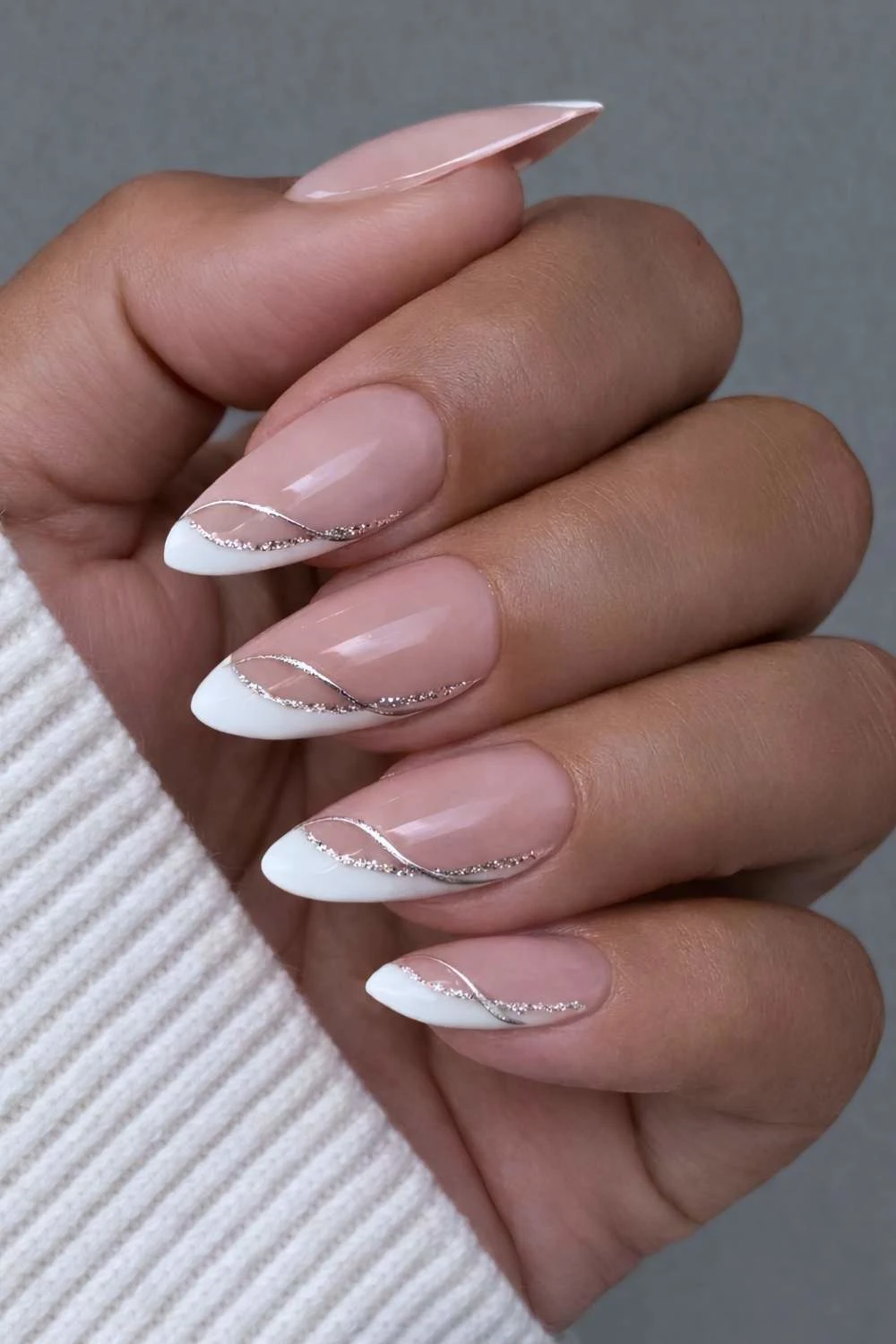 Angled white French mani with glitter accents