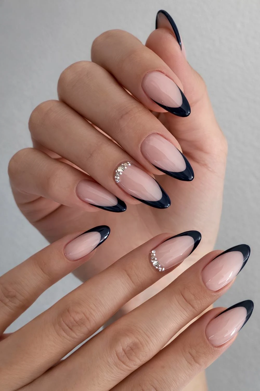 Black French manicure with accent gems