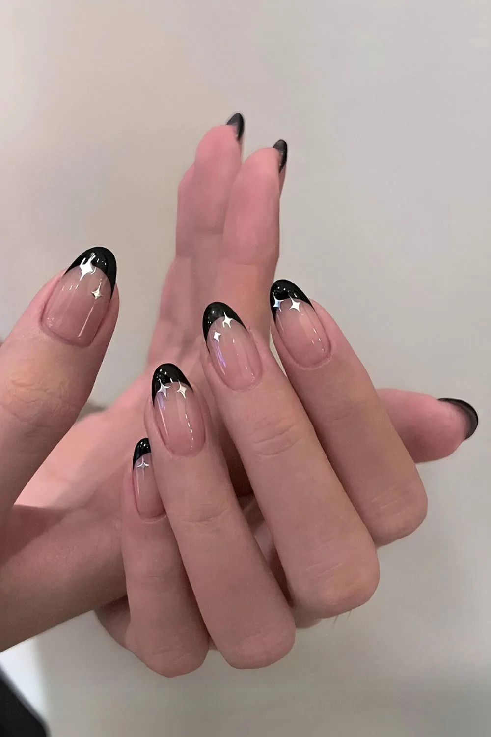 Black French tips with tiny celestial accents