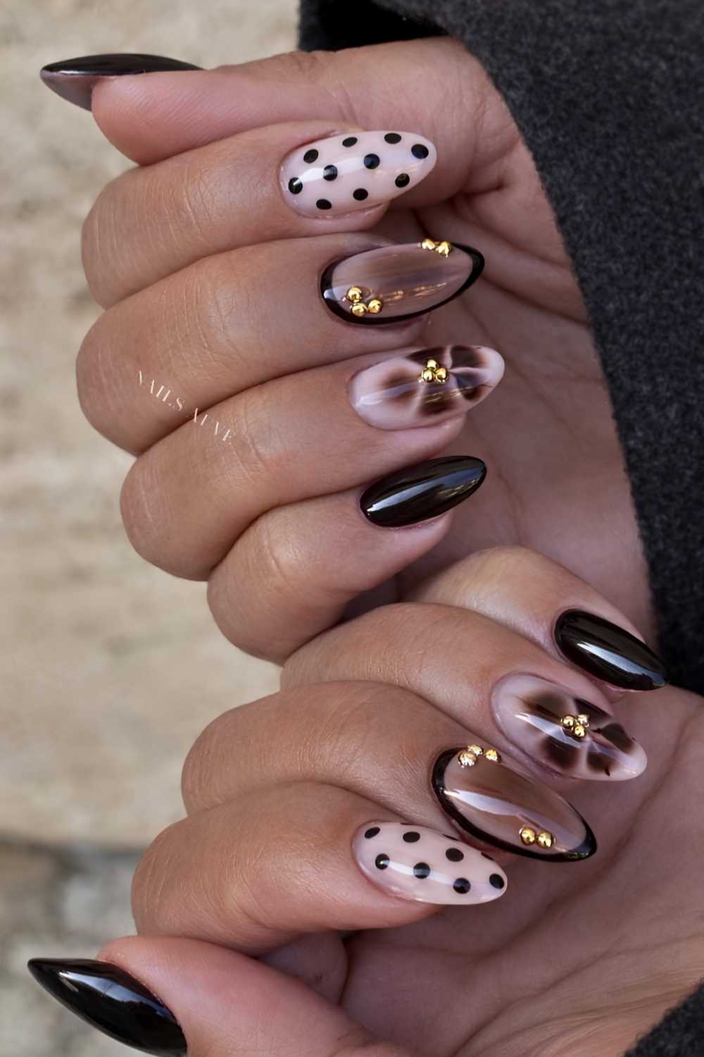 Black and brown nails with polka dots and gold details