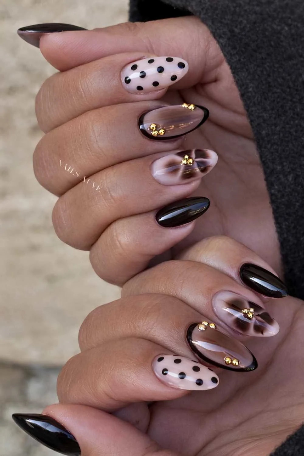 Black and brown nails with polka dots and gold details