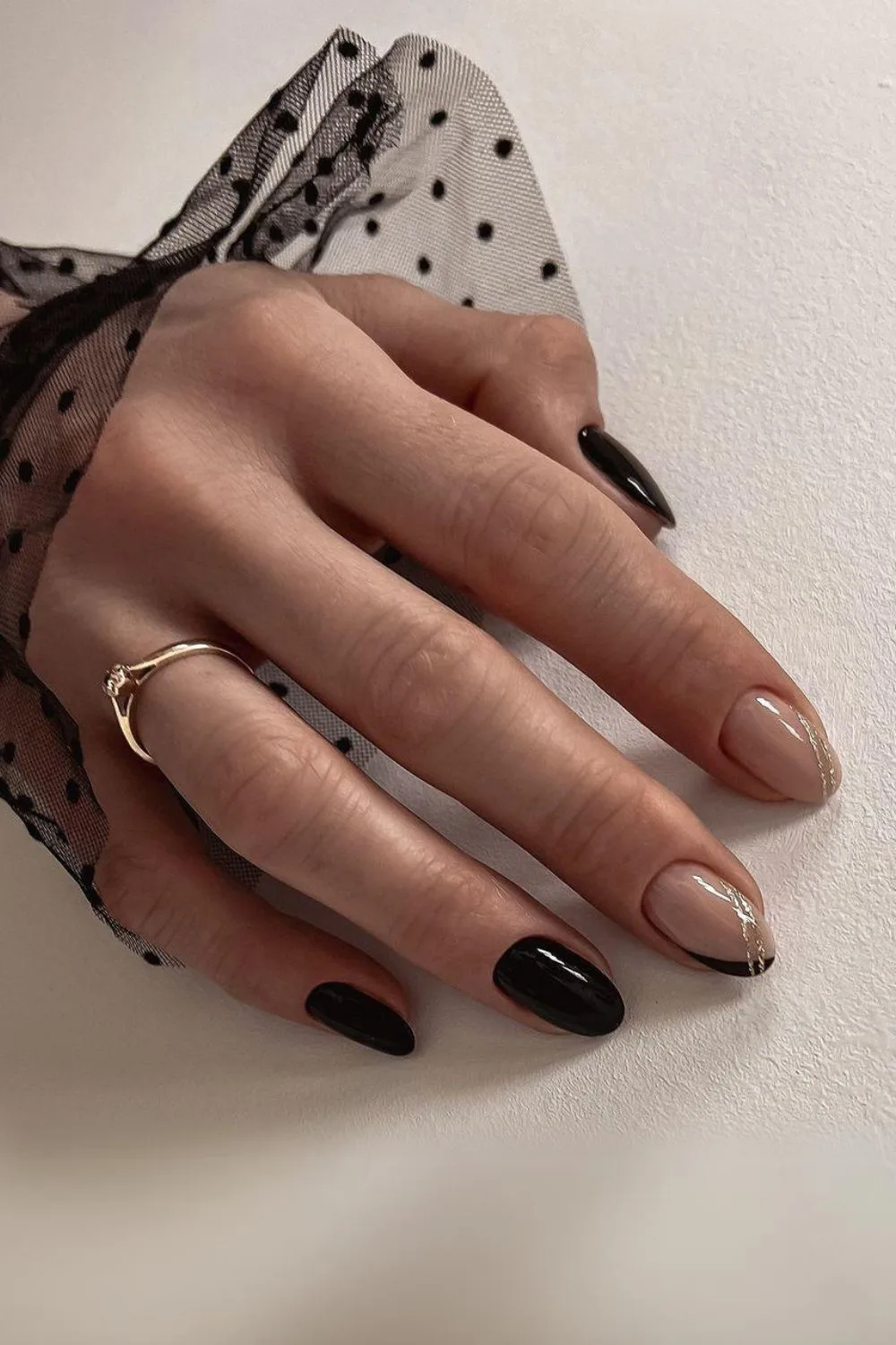 Black and nude nails with gold lines