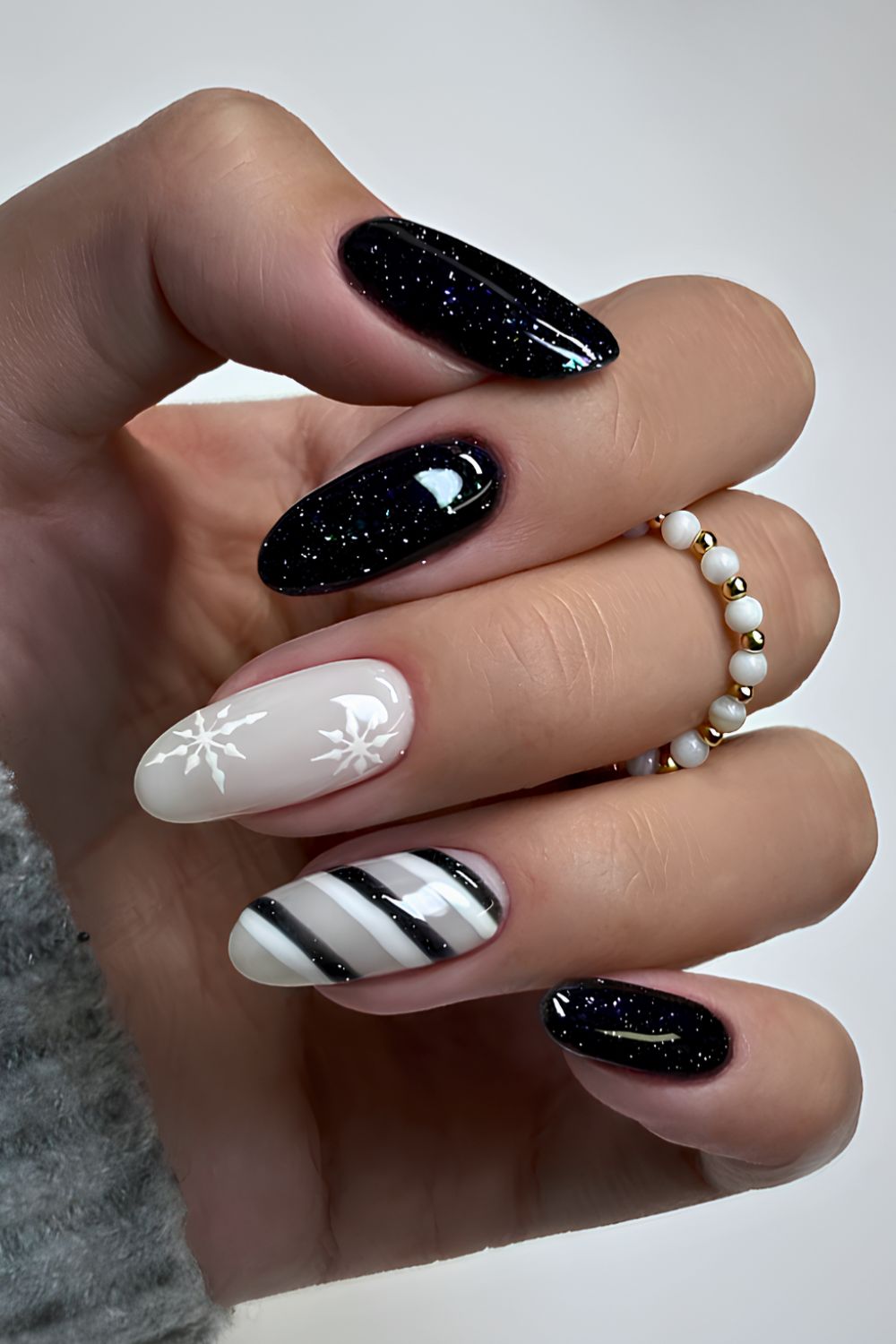 Black and white nails with stripes and snowflakes
