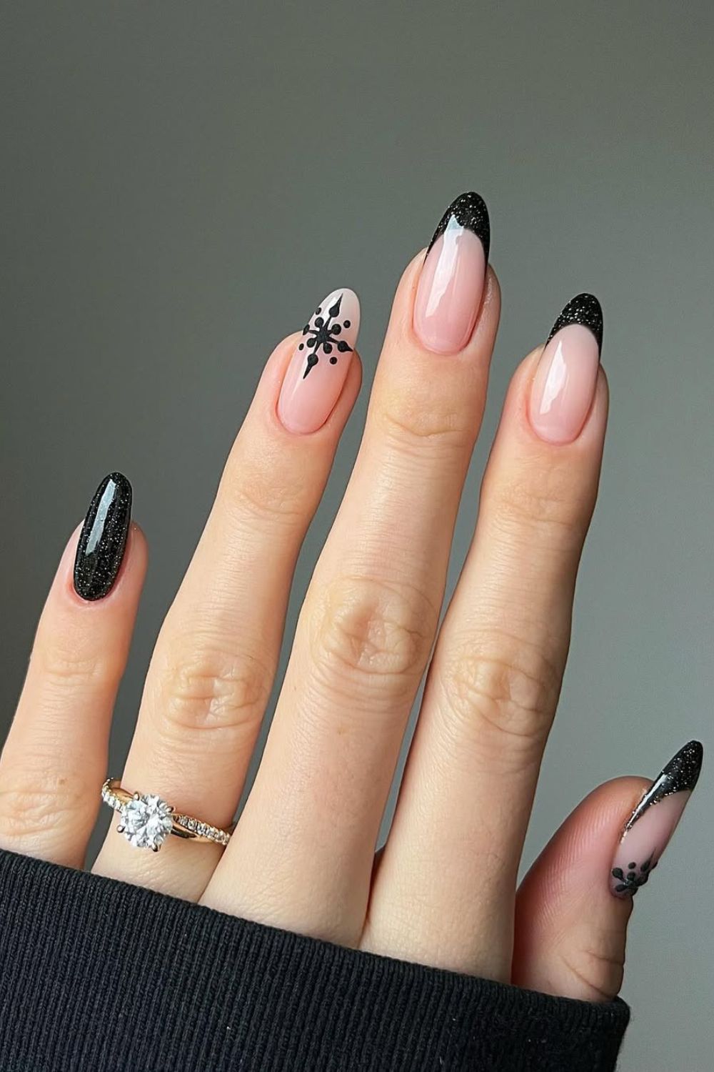 Black glitter french tip nails with snowflake accent