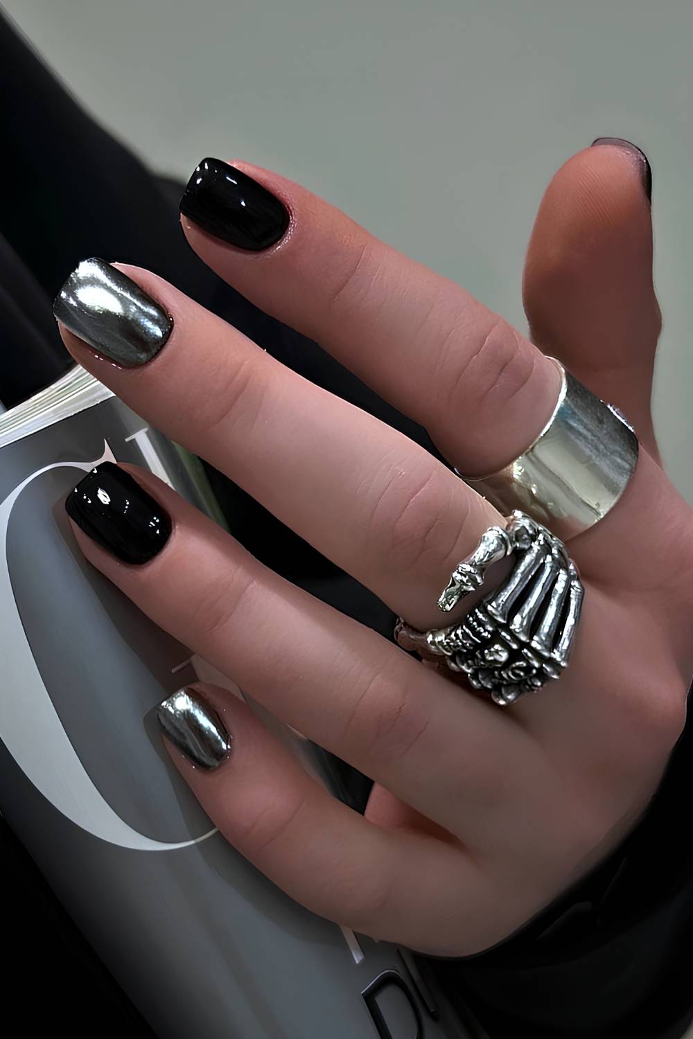 Black manicure with silver chrome accent nails