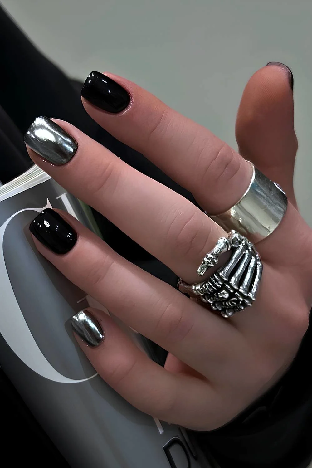 Black manicure with silver chrome accent nails