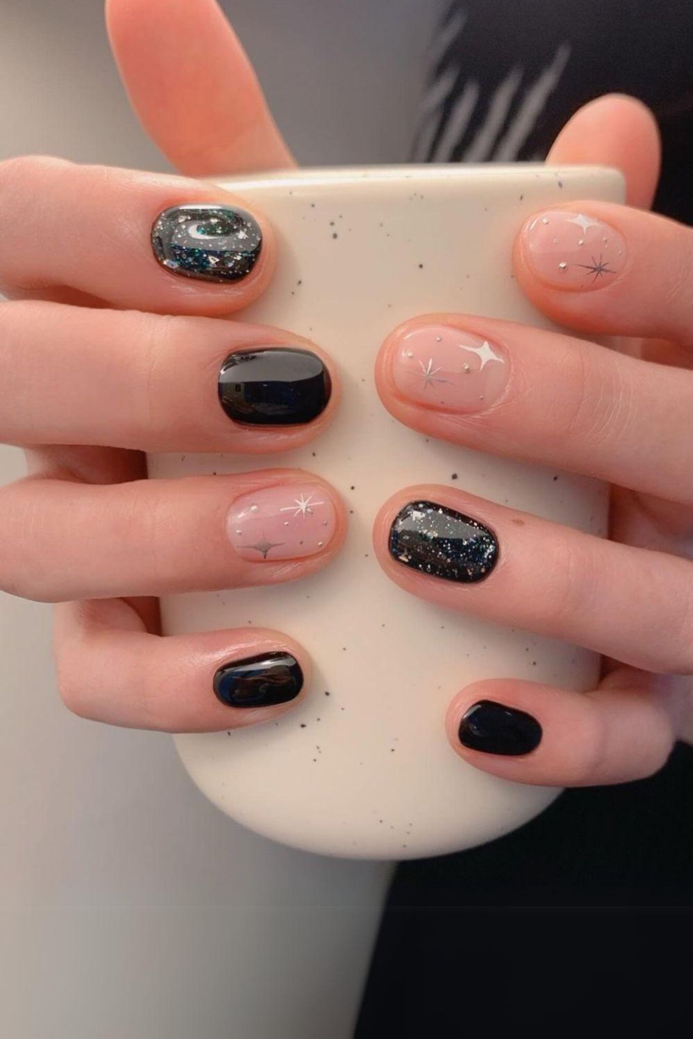 Black nails with glitter and silver chrome stars