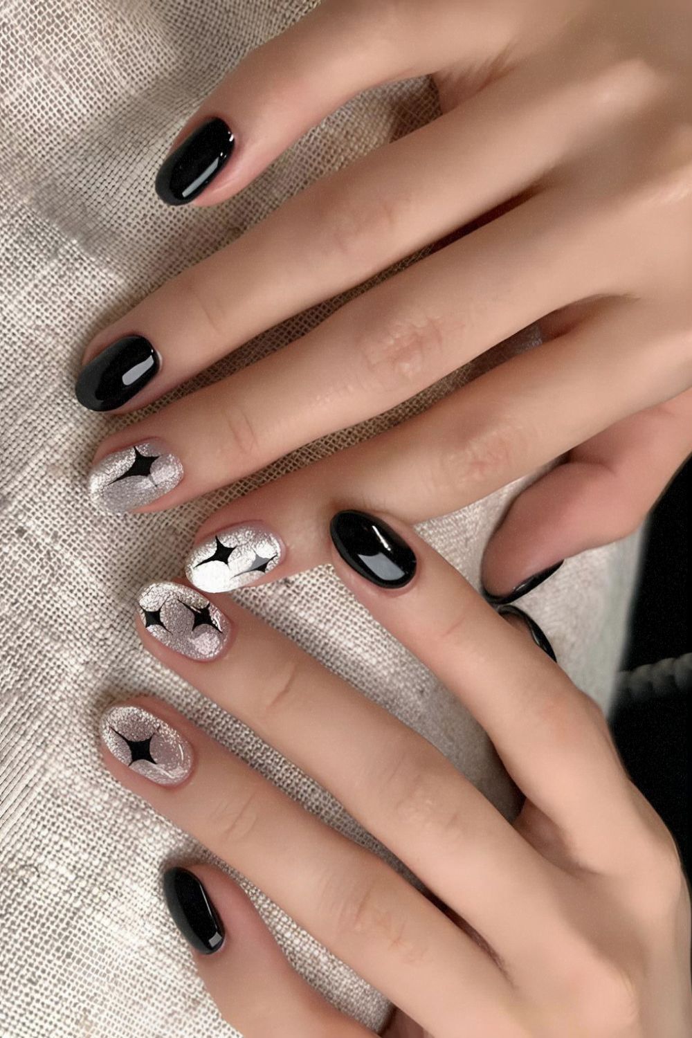 Black nails with silver cat-eye effect accent