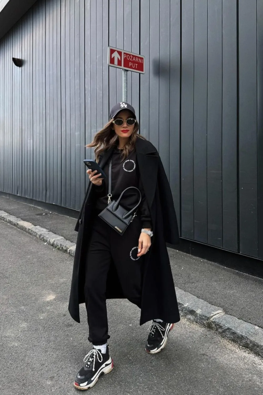 Black tracksuit with long black coat and sneakers