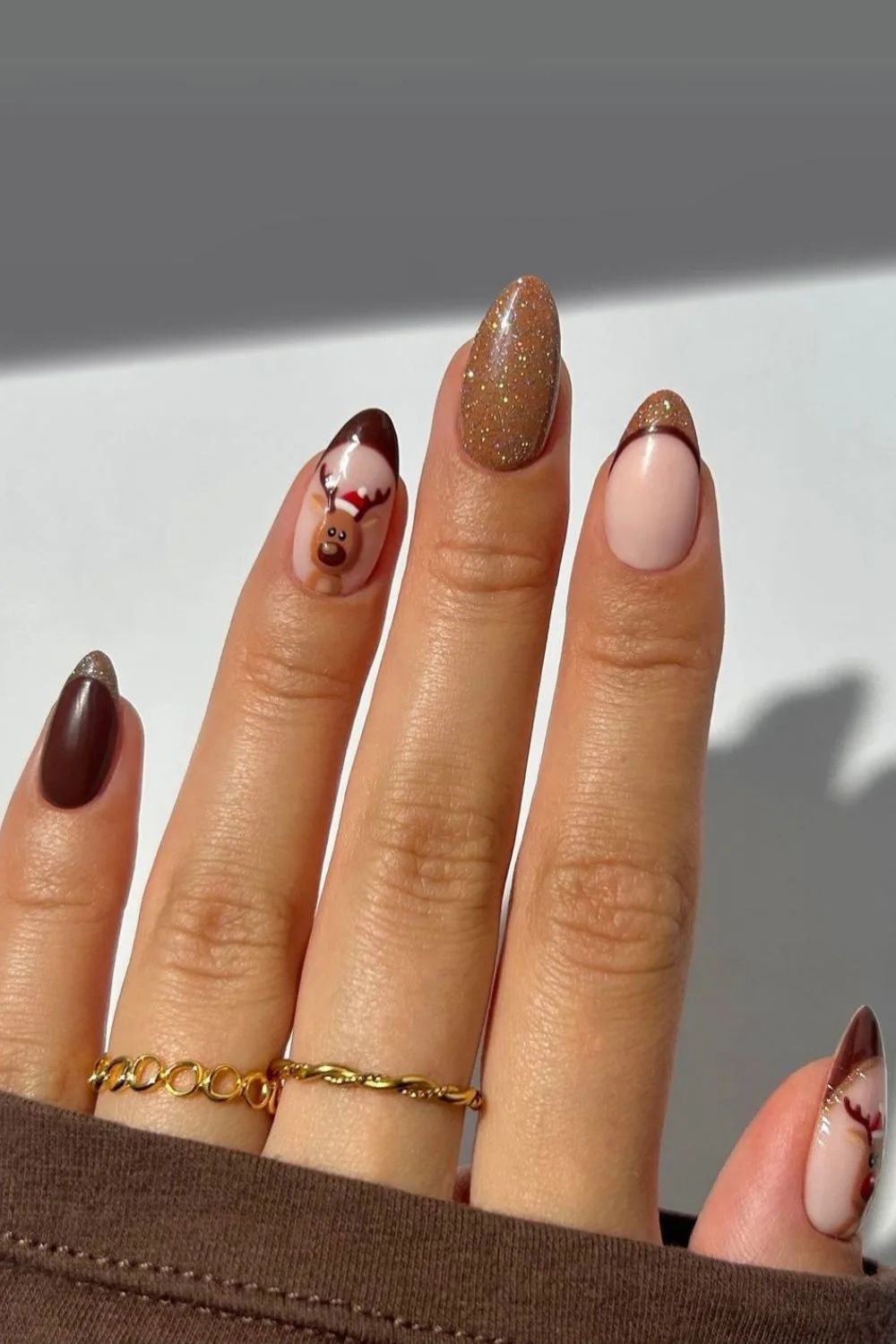 Brown french tip nails with reindeer accent