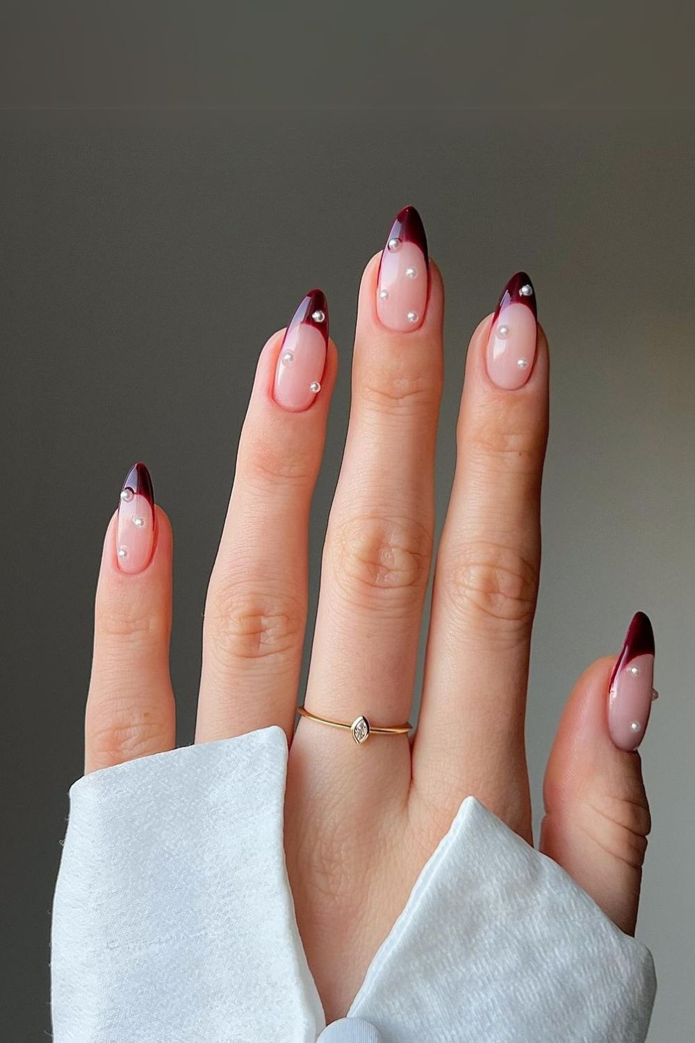 Burgundy French tip nails with pearl stickers