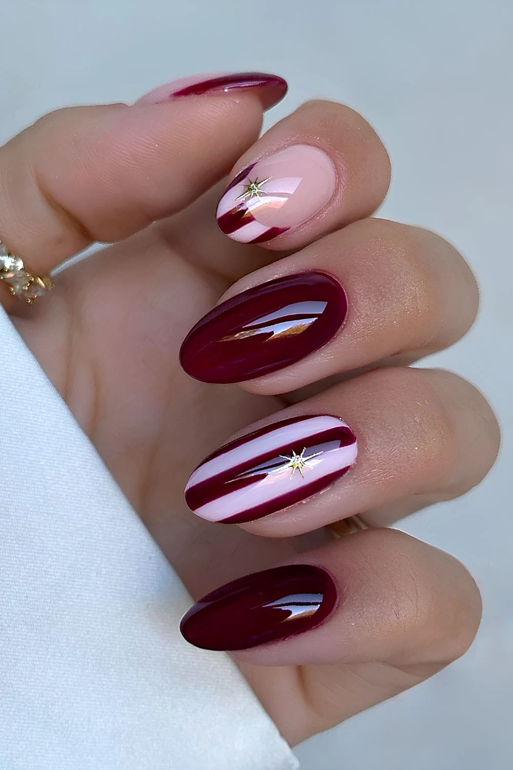 Burgundy and white Christmas nails with stripe art