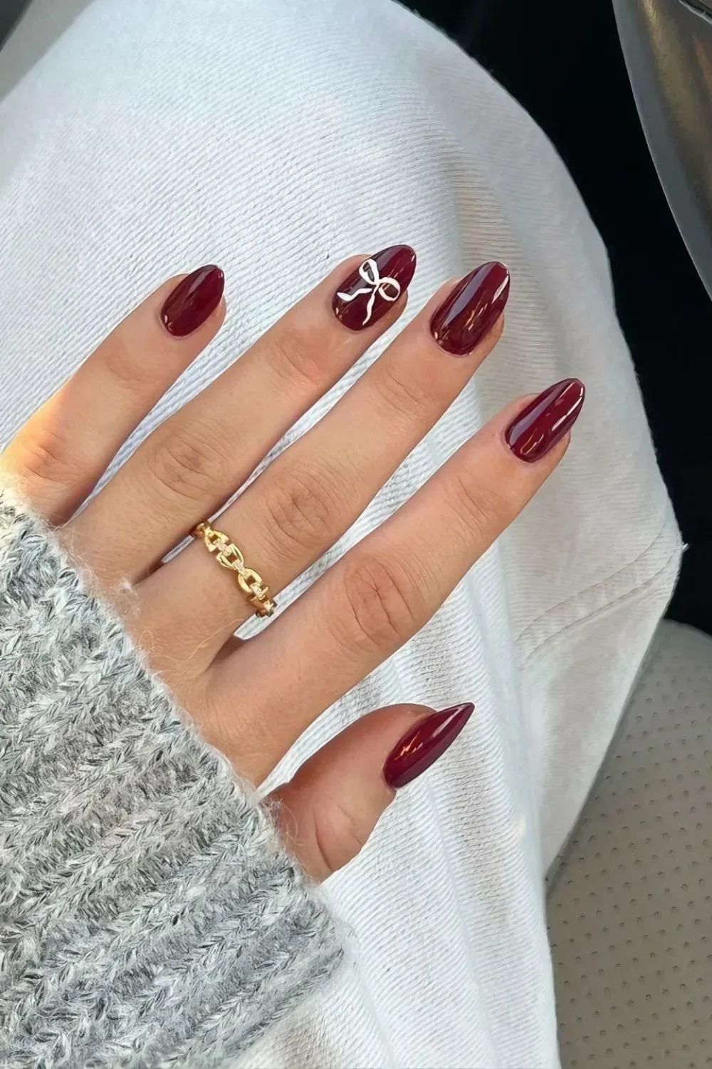 Burgundy nails with bow accent