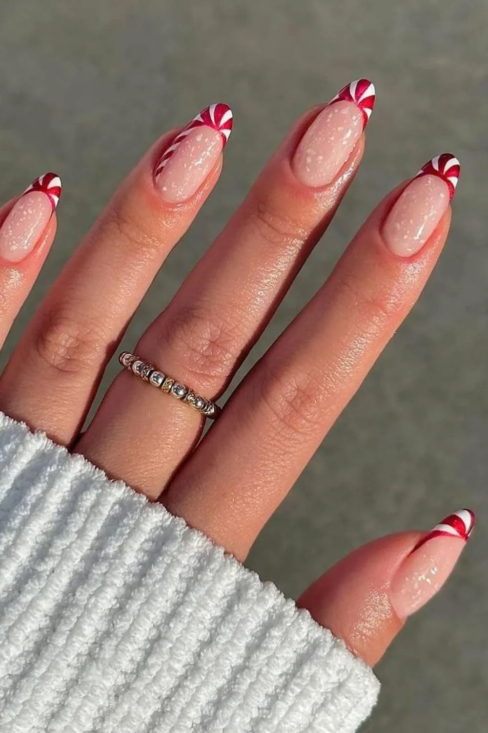 Candy cane french tip nails with snowy accents