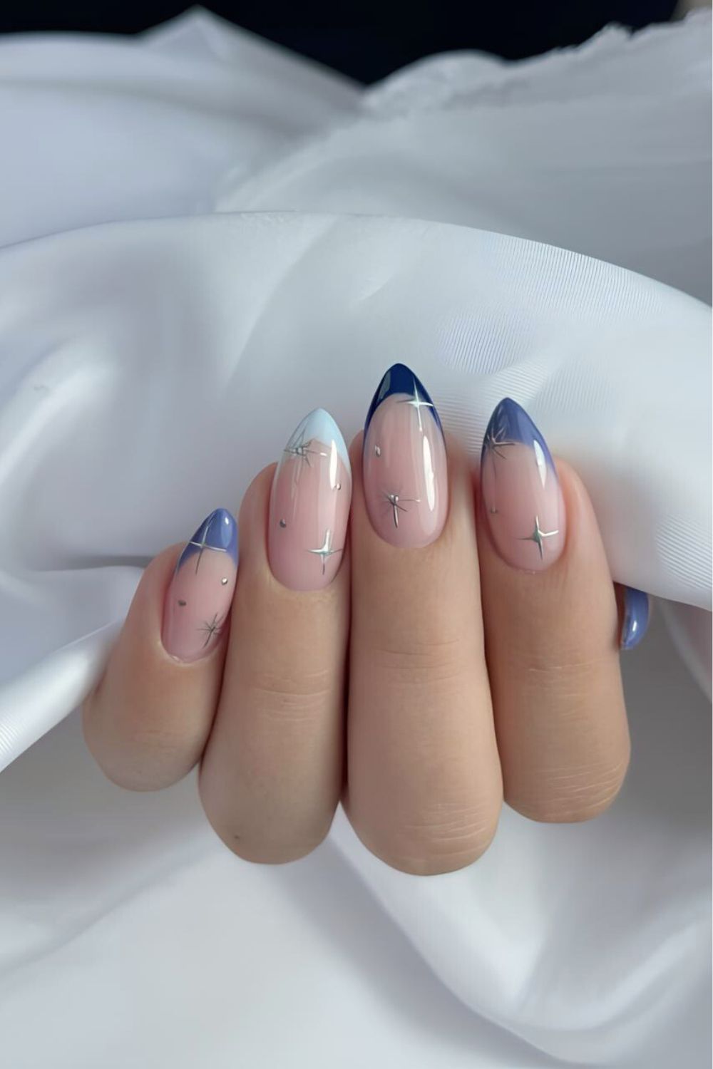 Celestial French tip nails in different blue shades