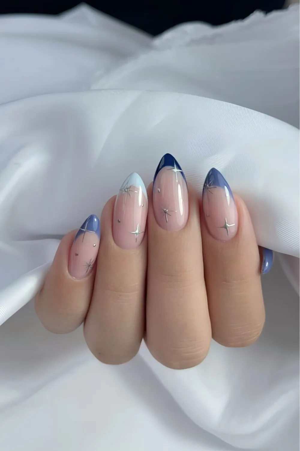 Celestial French tip nails in different blue shades