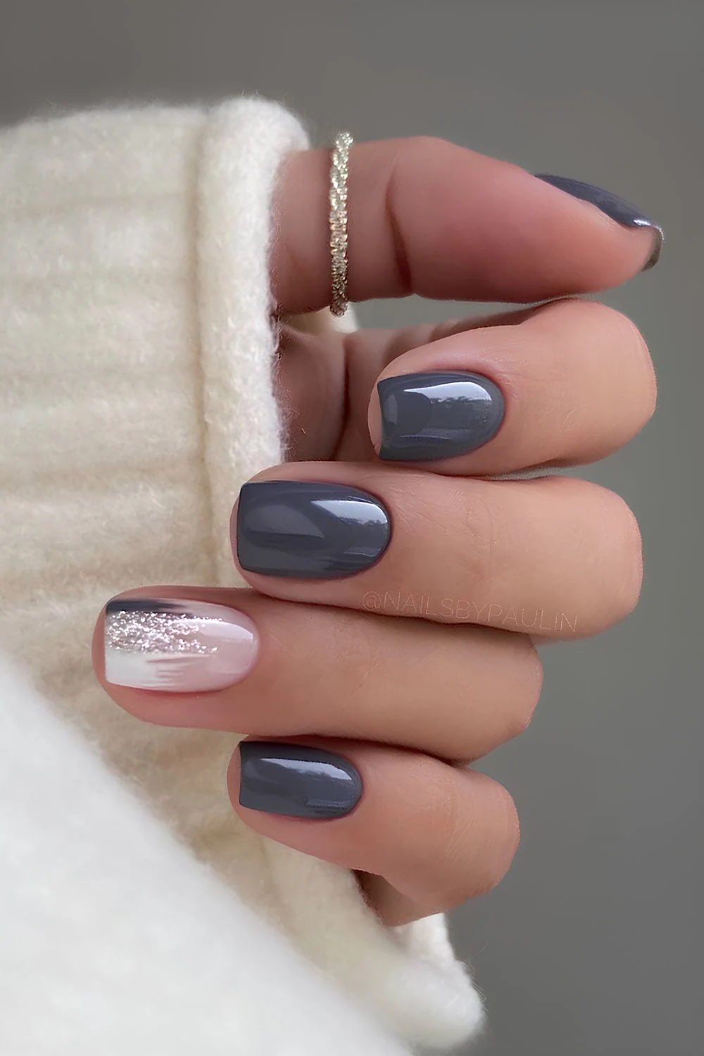 Charcoal gray nails with glitter accent