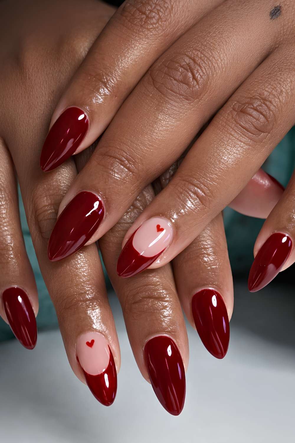 Cherry red nails with micro heart art