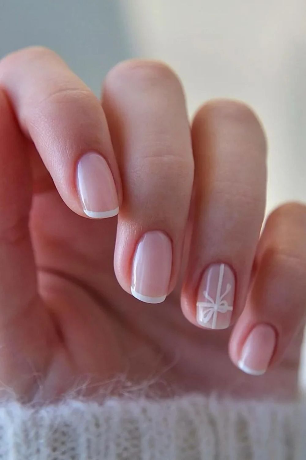 Classic French manicure with white ribbon