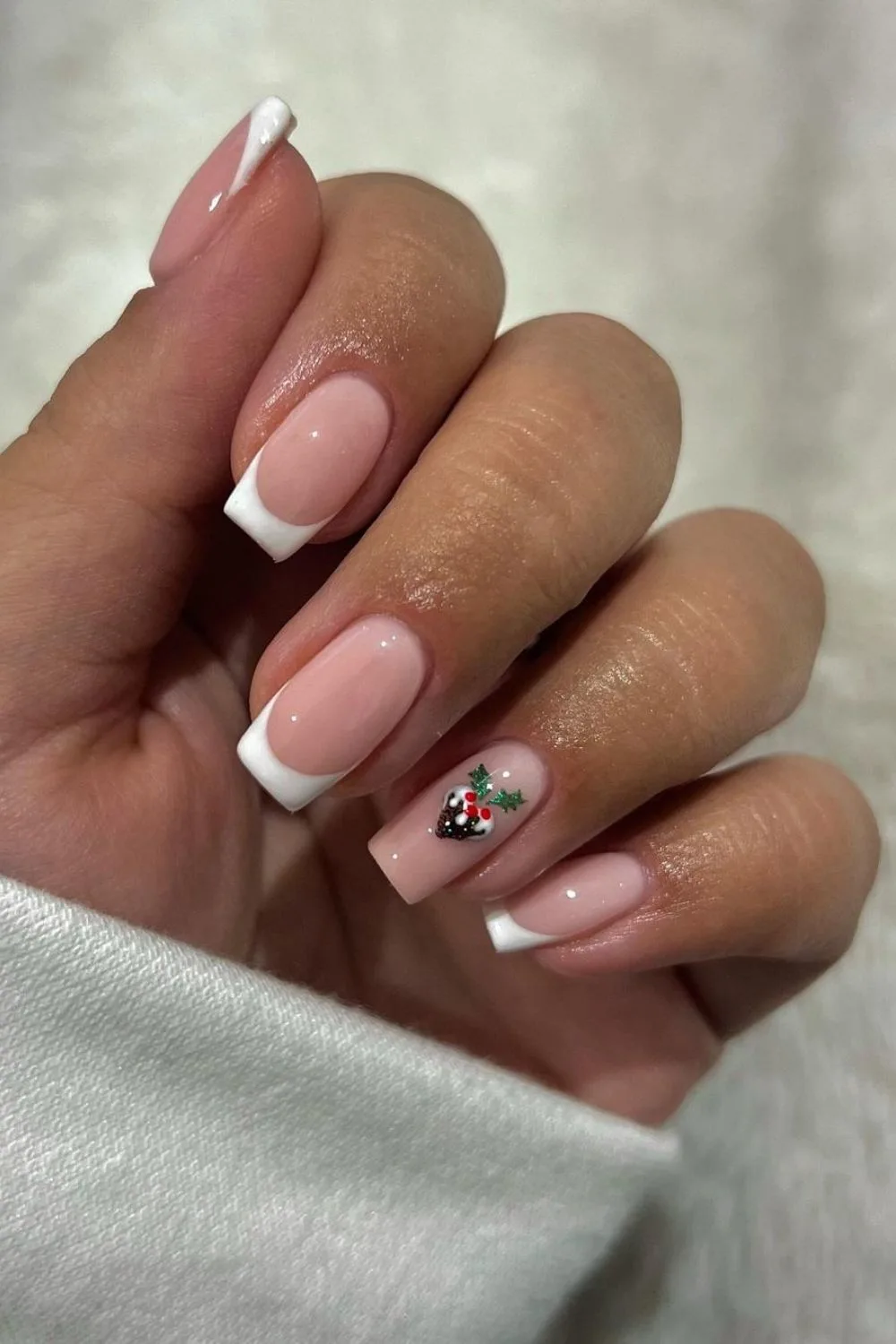 Classic French tip nails with christmas pudding accent