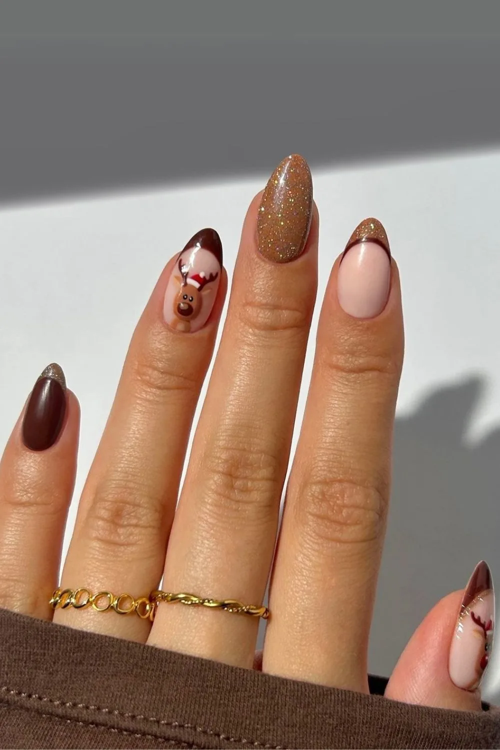 Dark and light brown nails with reindeer accent