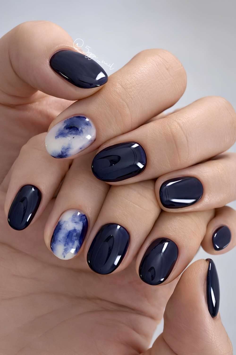 Dark blue nails with accent marble art