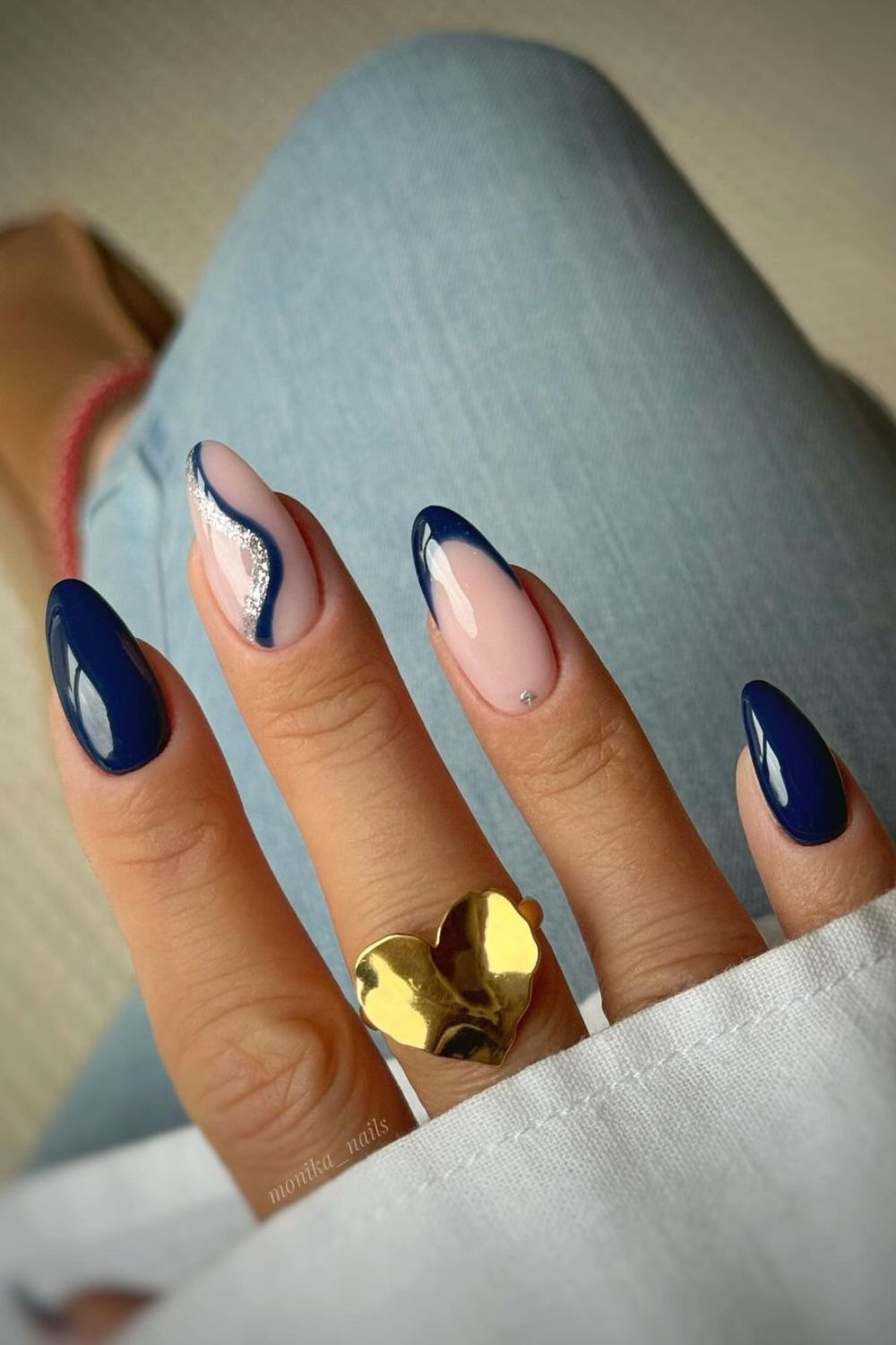 Dark blue nails with glittery swirl and french tip accent