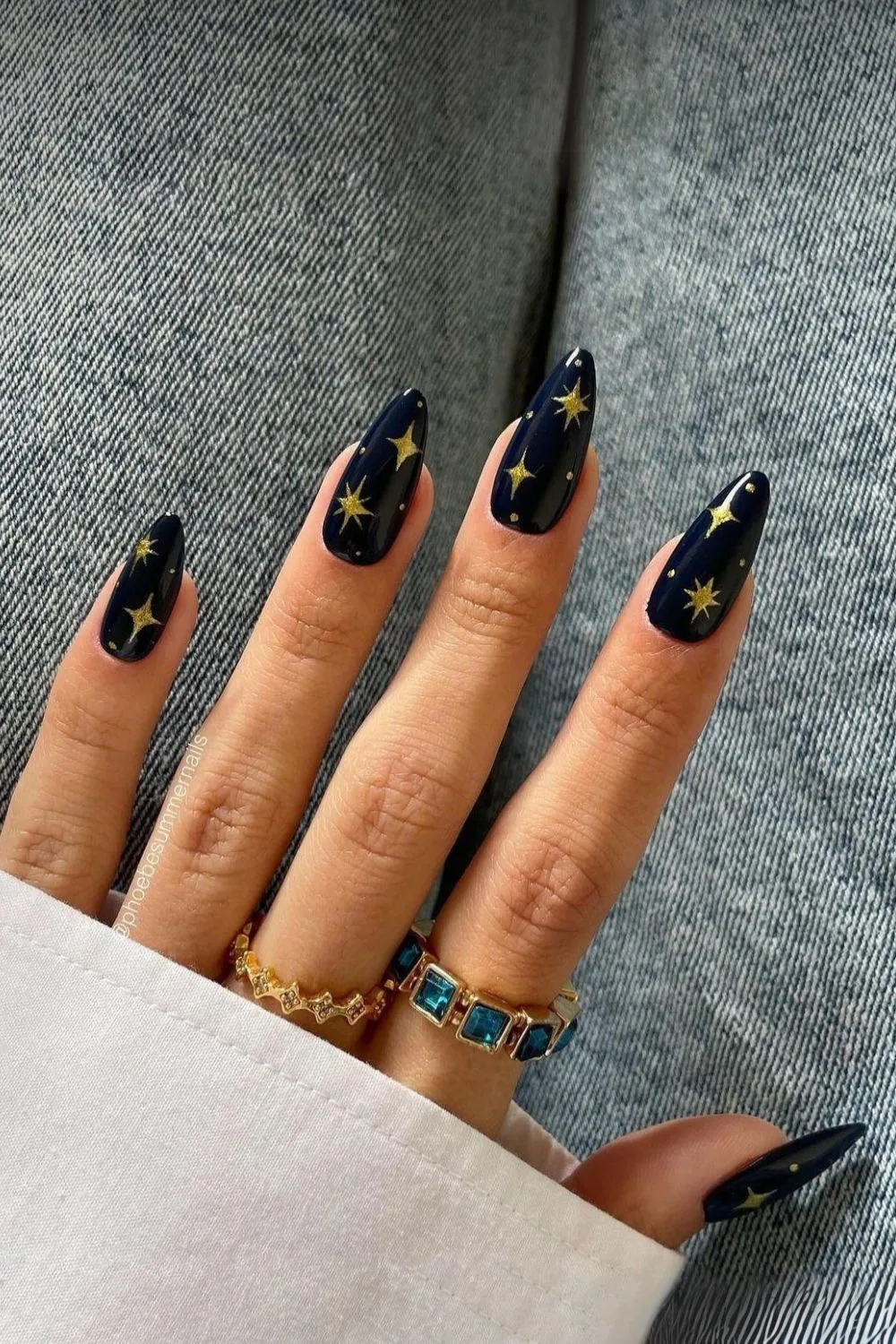 Dark blue nails with gold chrome stars