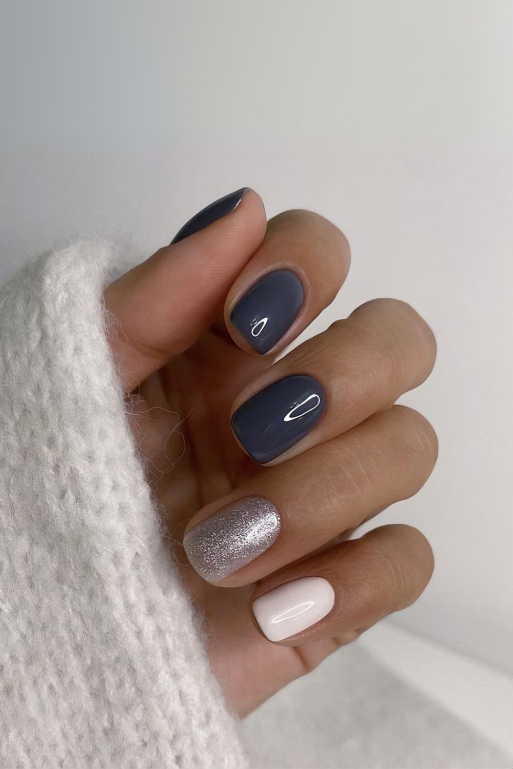 Dark gray and white nails with glitter accent