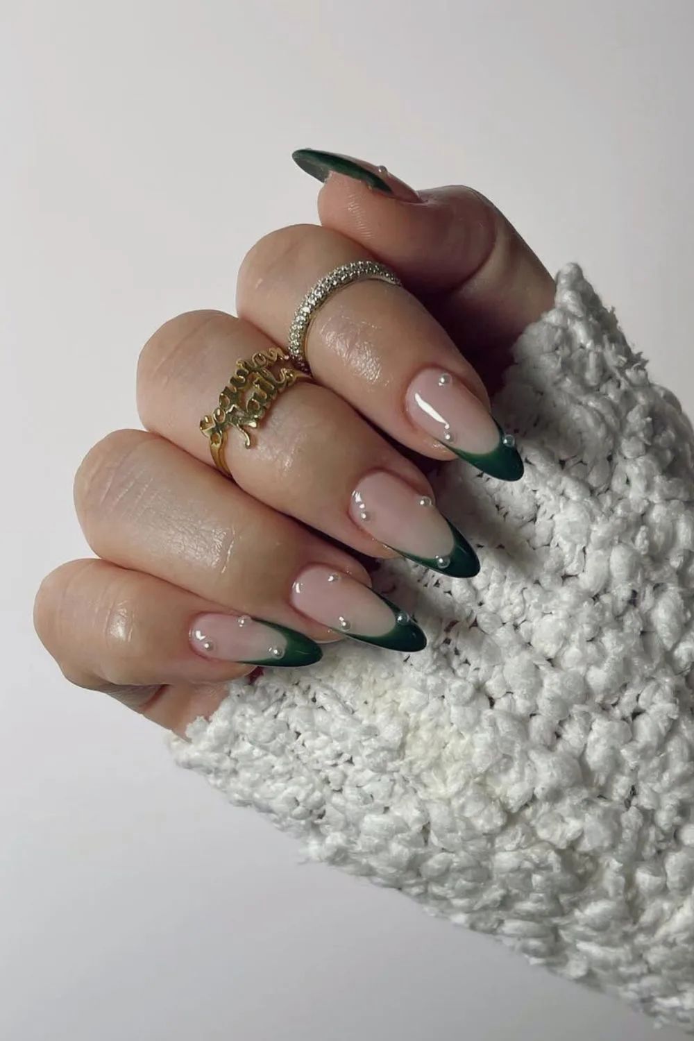 Dark green French tip nails with pearl accents